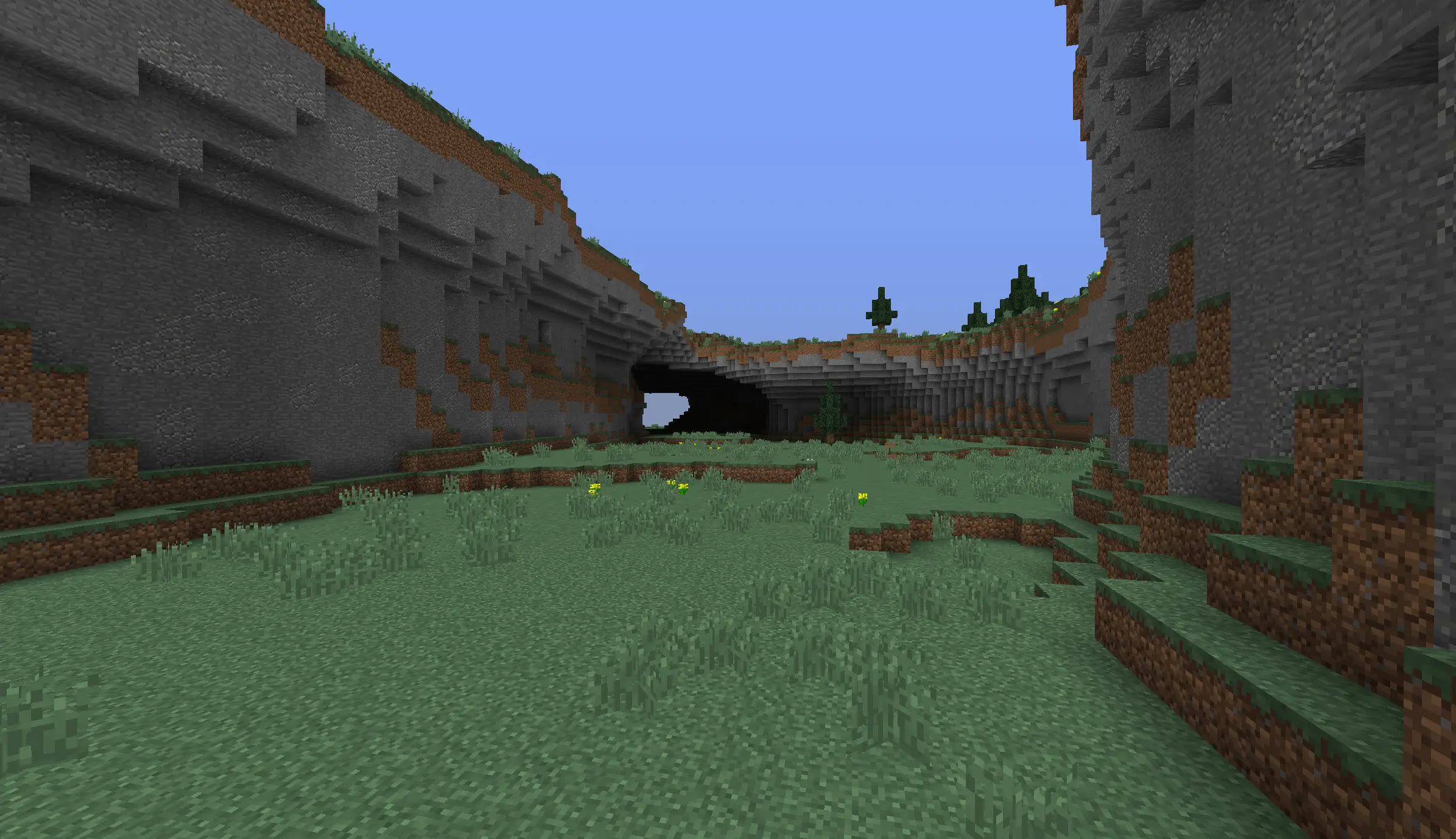 A grassy valley enclosed by high rock walls in RustV2's new basin biome